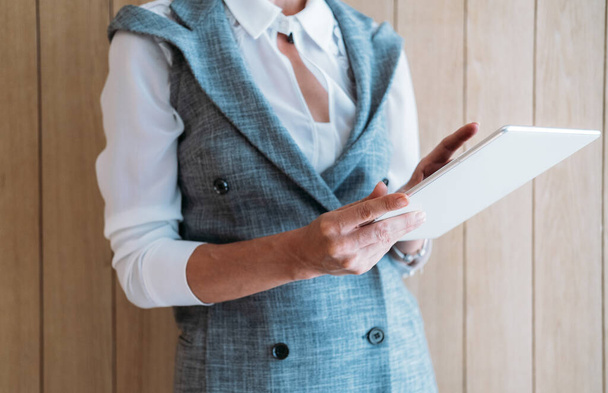 Cropped photo of business woman using white tablet - Fotoğraf, Görsel