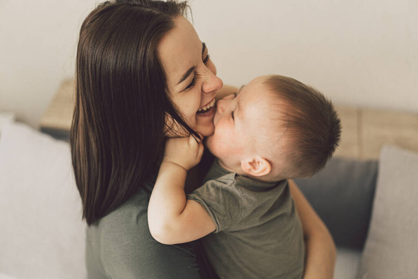 Happy loving family. Mom and his son are hug at home. Mother's day. Sweet home - Fotoğraf, Görsel