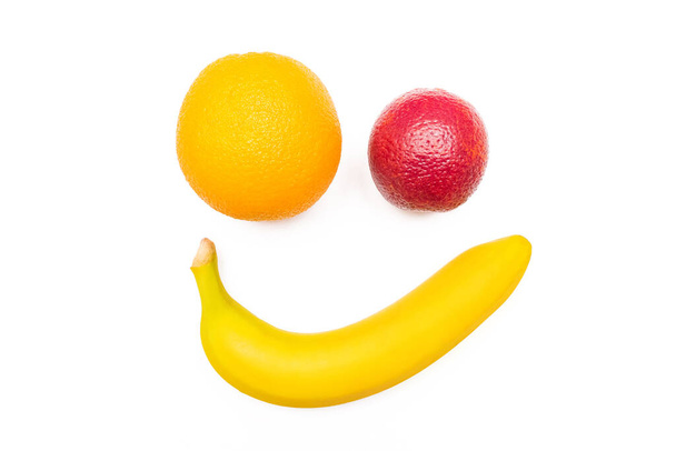 Smiling banana and funny red orange isolated on white background. - Photo, Image