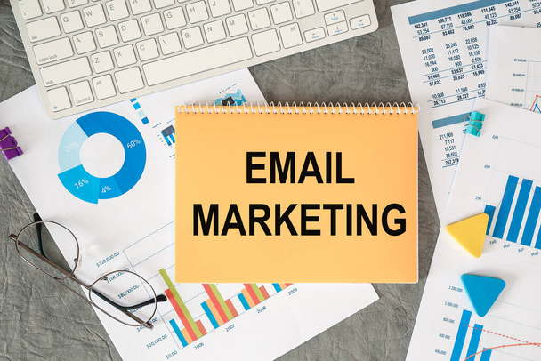 Email Marketing is written in a document on the office desk with office accessories. - Fotografie, Obrázek