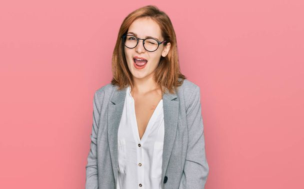 Young caucasian woman wearing business style and glasses winking looking at the camera with sexy expression, cheerful and happy face.  - Foto, Bild