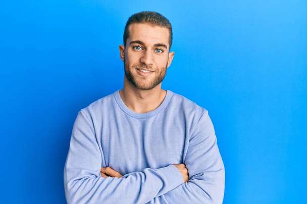 Young caucasian man wearing casual clothes happy face smiling with crossed arms looking at the camera. positive person.  - Photo, Image