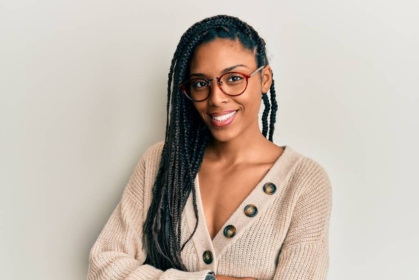 African american woman wearing casual clothes and glasses happy face smiling with crossed arms looking at the camera. positive person.  - Photo, Image