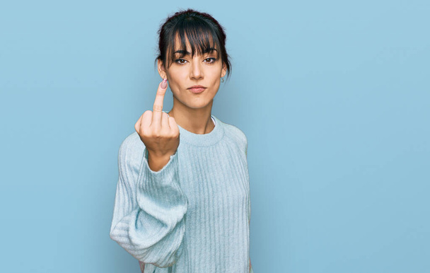 Young hispanic woman wearing casual clothes showing middle finger, impolite and rude fuck off expression  - Fotografie, Obrázek