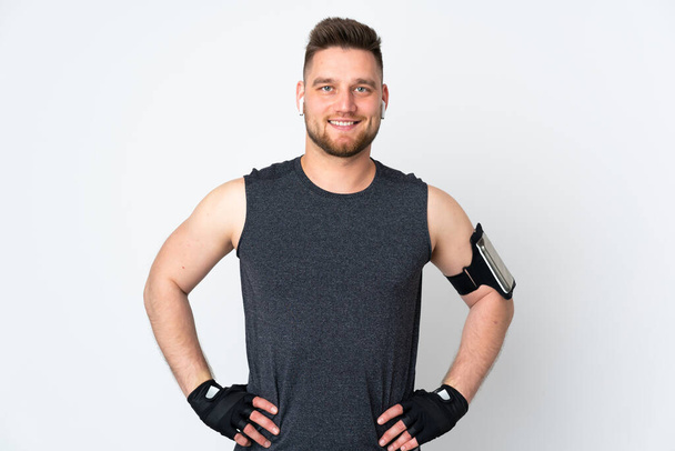 Russian sport man isolated on white background posing with arms at hip and smiling - Photo, Image