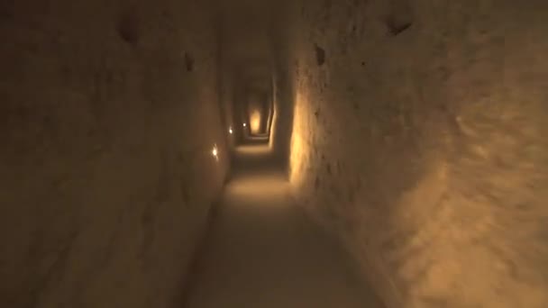 Egy hosszú folyosó összeköti a földalatti város szobáit.Földalatti védekező hely élő pince tároló pincék ciszternák csatorna keskeny út belül barlang ásott régi kőkorszak őskori neolitikus ház régészet 4K - Felvétel, videó