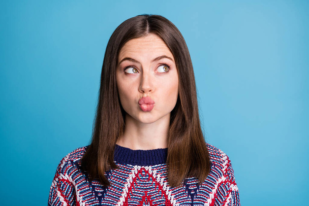Portrait of attractive girlish curious brown-haired girl thinking pout lips copy space isolated over vibrant blue color background - Foto, imagen