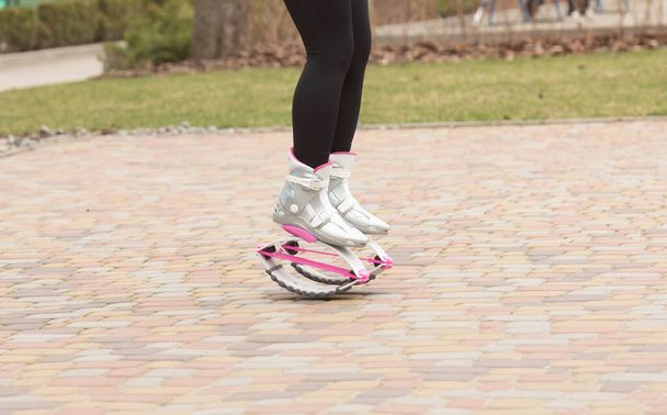 Cropped shot of woman in kangoo jumping boots. Sport training concept. Fitness instructor. - Foto, immagini