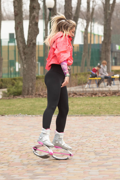 Woman fitness instructor in kangoo jumping boots. Sport training concept.  - 写真・画像