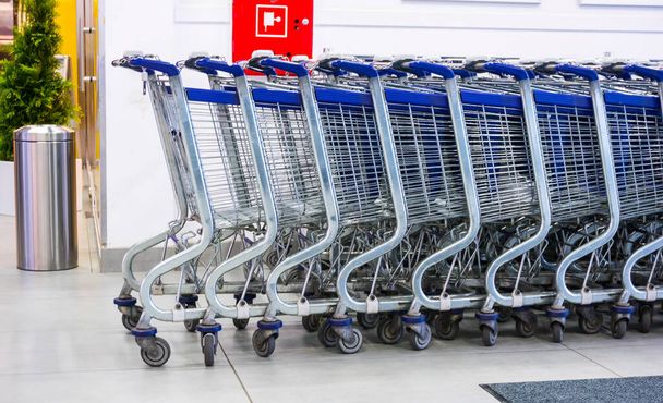 POZNAN, POLAND - Apr 10, 2016: Row of shopping carts of a Piotr i Pawel supermarket - Zdjęcie, obraz