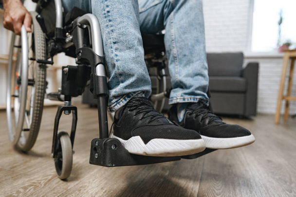 Unrecognizable disabled man sitting in a wheelchair - Fotó, kép