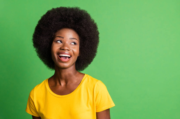 Photo of young happy smiling good mood african woman look copyspace laughing isolated on green color background - Fotó, kép