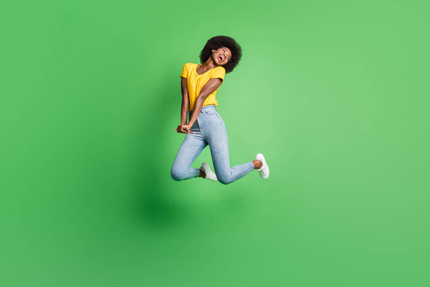 Full size photo of young beautiful charming smiling lovely dreamy girl jumping look copysapace isolated on green color background - Φωτογραφία, εικόνα