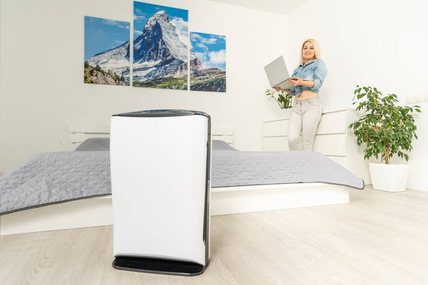 Modern air humidifier and blurred woman resting on background - Photo, Image