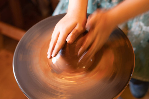 Potter's hands. Making clay products on a potter's wheel. Pottery master class - Photo, Image