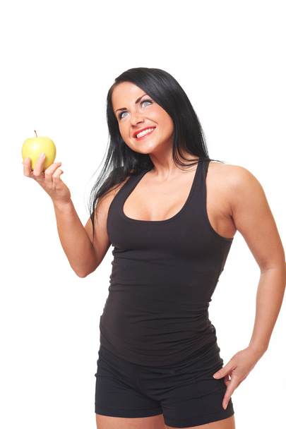 Fitness girl with green apple isolated on white - Fotó, kép