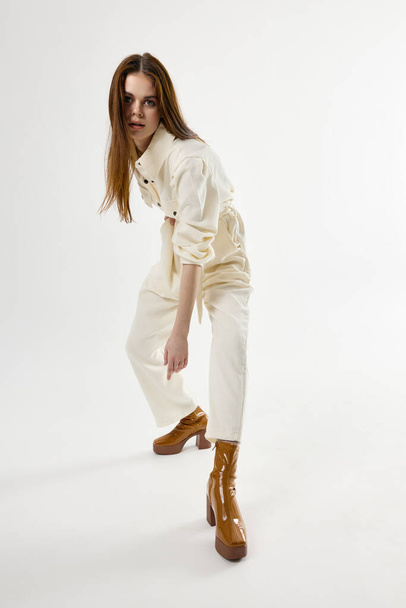 attractive woman wearing brown boots bent forward posing glamor - Fotografie, Obrázek