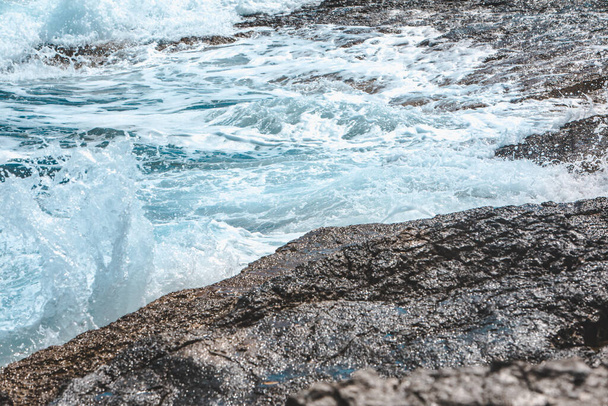 view of rocky seaside waves with white foam. copy space - Zdjęcie, obraz