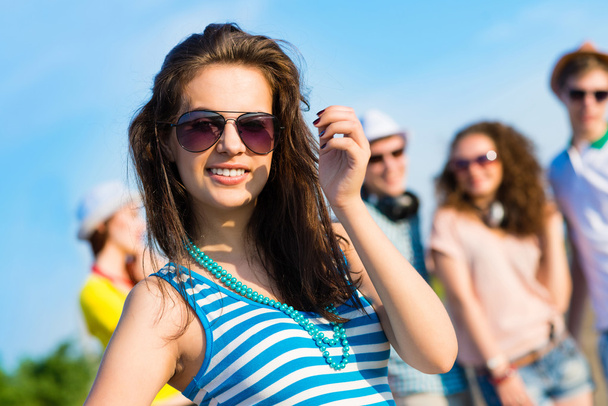 stylish young woman in sunglasses - Фото, изображение
