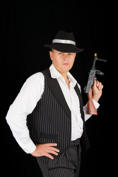 Dangerous gangster with 1920 style clothes standing with gun - Fotoğraf, Görsel