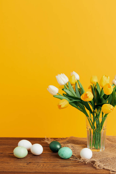 eggs tulip bouquet spring holiday easter yellow background - Фото, изображение