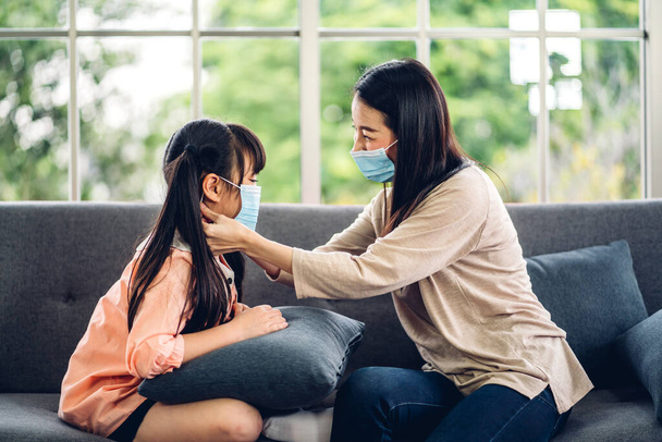 Portrait of enjoy happy love asian mother wearing protective mask for little asian girls child in quarantine for coronavirus with social distancing at home.covid19 concept - Φωτογραφία, εικόνα