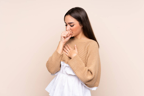 Young caucasian woman isolated on beige background is suffering with cough and feeling bad - 写真・画像