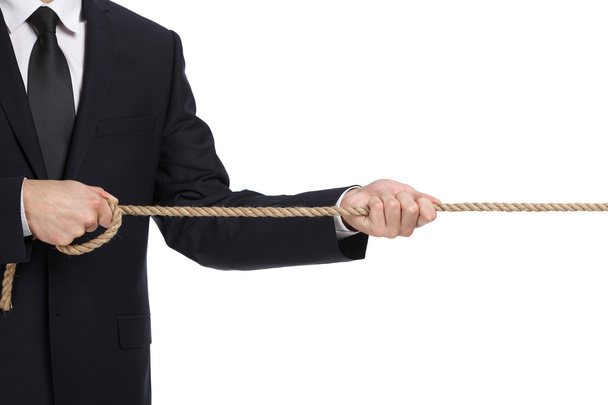 Close up of businessman pulling the rope - Фото, изображение