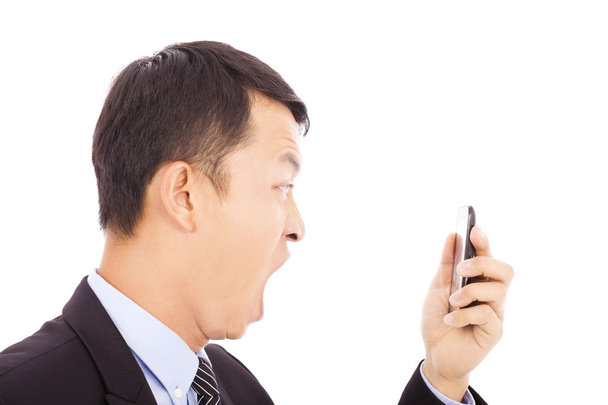 biznesmen krzyk w inteligentny telefon na białym - Zdjęcie, obraz