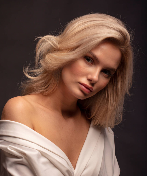 Blonde hair female model posing on camera  - Photo, image