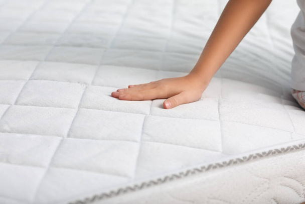 Little girl touching soft orthopedic mattress, closeup - Zdjęcie, obraz