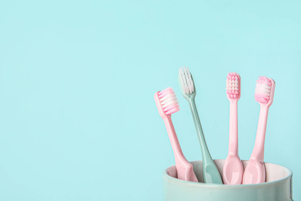 Tooth brushes on color background - Foto, Bild