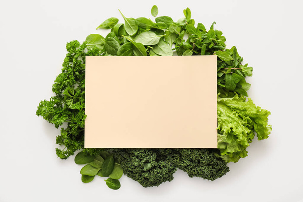 Fresh green vegetables, herbs and blank card on white background - Photo, Image