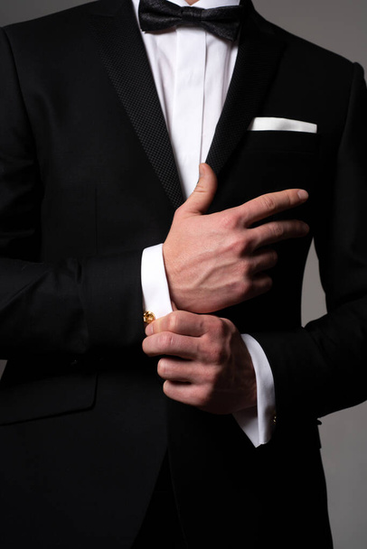 Retro suit fashion. Formal classic suit. Business style outfit. Handsome businessman adjusting his sleeves. - Fotó, kép