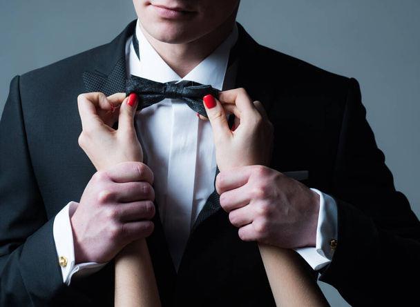 Gentleman suit. Wedding. Womens hands straighten tie. Male fashion. Business look. Elegant and stylish clothes. - Foto, Bild
