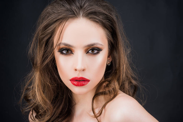 Elegant woman with red lips and smokey eyes makeup. Closeup face with make-up. - Foto, afbeelding