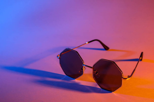 Stylish sunglasses on color background - 写真・画像
