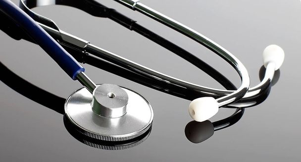 Beautiful stethoscope on the reflection grey background - Photo, Image