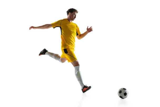 Young man, male soccer football player training isolated on white background. - Fotoğraf, Görsel