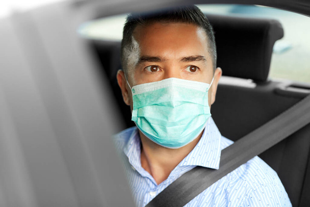 man or male passenger wearing mask in car - Zdjęcie, obraz
