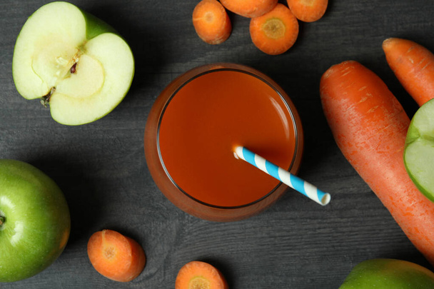 Glass of juice and ingredients on dark wooden background - Photo, Image
