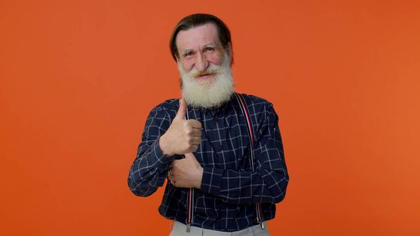 Старший старий бородатий чоловік піднімає великі пальці вгору погоджується з чимось або дає позитивну відповідь, як добре
 - Фото, зображення