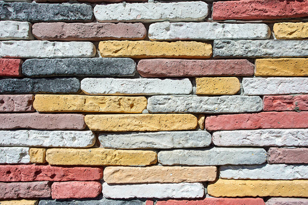 Wall of colored homemade bricks as texture for background. - 写真・画像