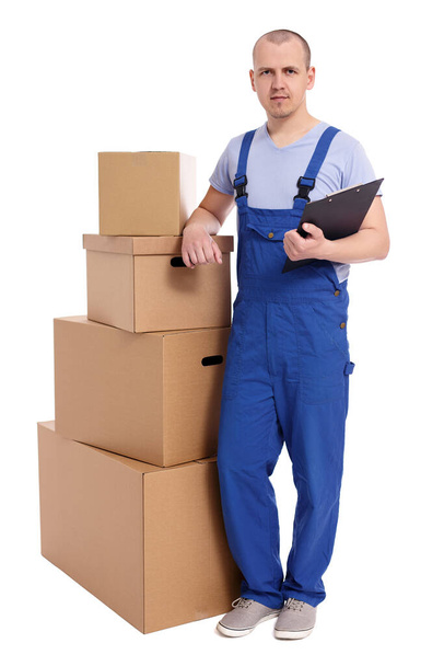 full length portrait of loader man with heap of boxes and clipboard isolated on white background - Photo, Image