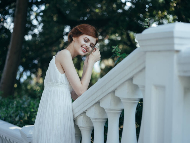 Beautiful woman in white dress classic style and luxury charm nature vacation - Foto, afbeelding