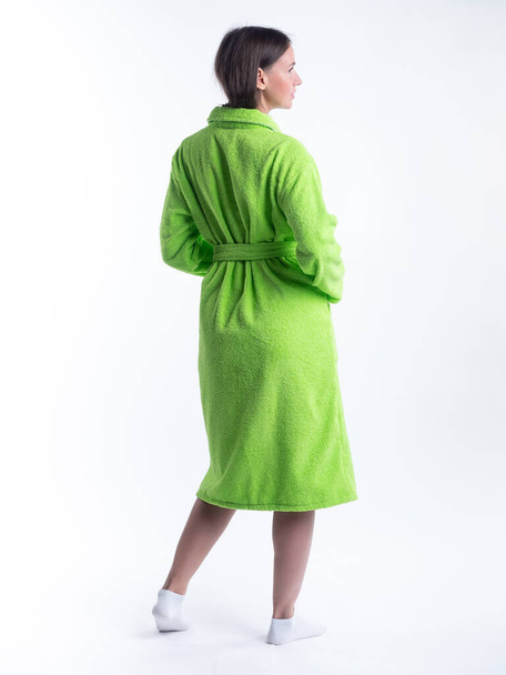 woman in a dressing gown from the back on an isolated white background. Shot in the Studio in full growth. - Fotó, kép