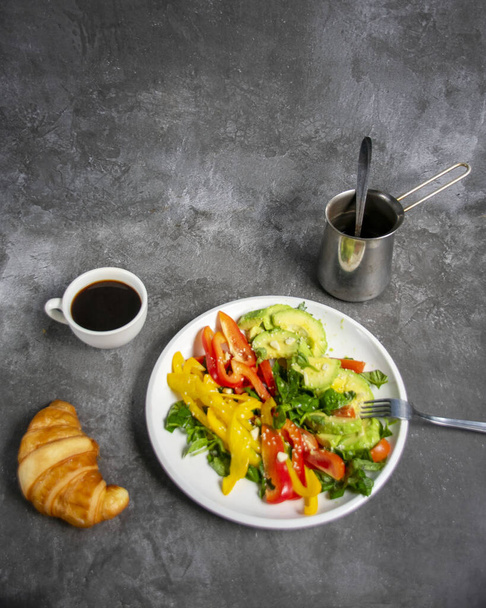 breakfast, avocado salad basil tomato and paprika, coffee with croissant - Fotó, kép