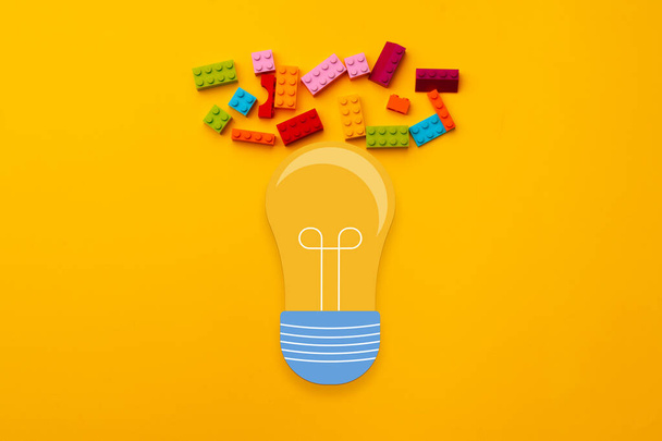 Ideas concept with light bulb and toy constructor details - Φωτογραφία, εικόνα