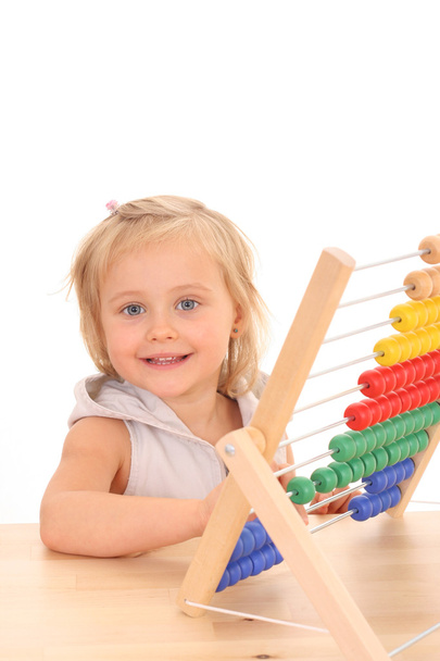 4 years old girl with abacus at desk isolated on white - Φωτογραφία, εικόνα