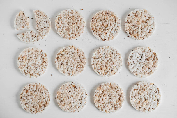 Round diet crispbreads on a white background. Round shaped cereal bread, healthy food without yeast. Top view. Copy, empty space for text. - Fotó, kép